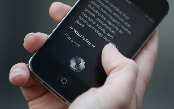 Luke Peters demonstrates Siri, an application which uses voice recognition and detection on the iPhone 4S, outside the Apple store in Covent Garden, London