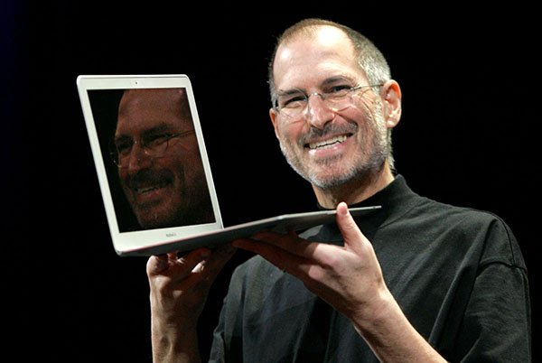 Apple CEO Steve Jobs holds up the new MacBook Air while giving the keynote address at Apple MacWorld Conference in San Francisco, Tuesday, Jan. 15, 2008. The super-slim new laptop is less than an inch thick and turns on the moment it's opened. (AP Photo/Jeff Chiu) ORG XMIT: CAJC105