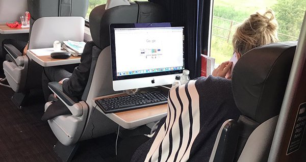 uk woman use heavy imac on train 00